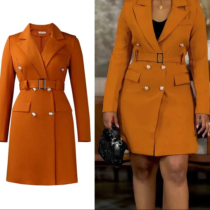 Orange trench coat with silver buttons on a white background, worn by a person.