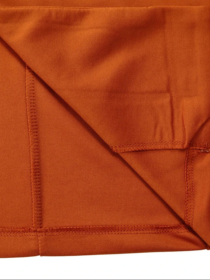 A close-up of an orange-brown fabric, likely a bed sheet or duvet cover, folded diagonally to show its texture and stitching. The brand name 'Maisoor' is printed in white script in the top-left corner.