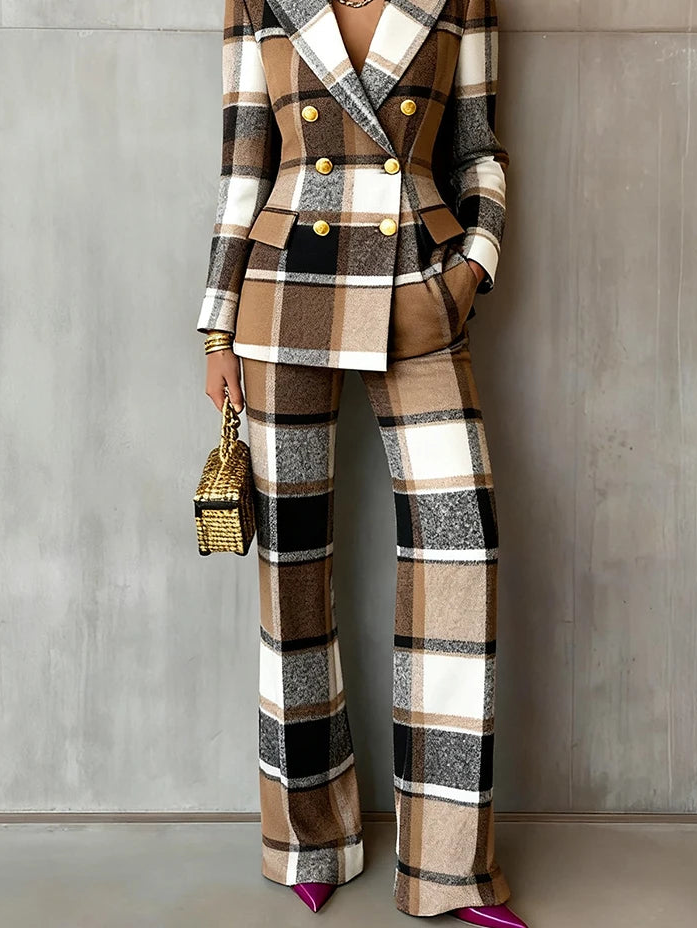 Person wearing a plaid suit with gold buttons against a gray background
