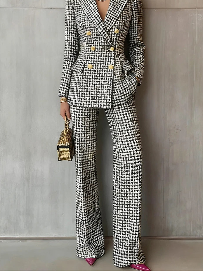 Person wearing a houndstooth patterned suit with a neutral background