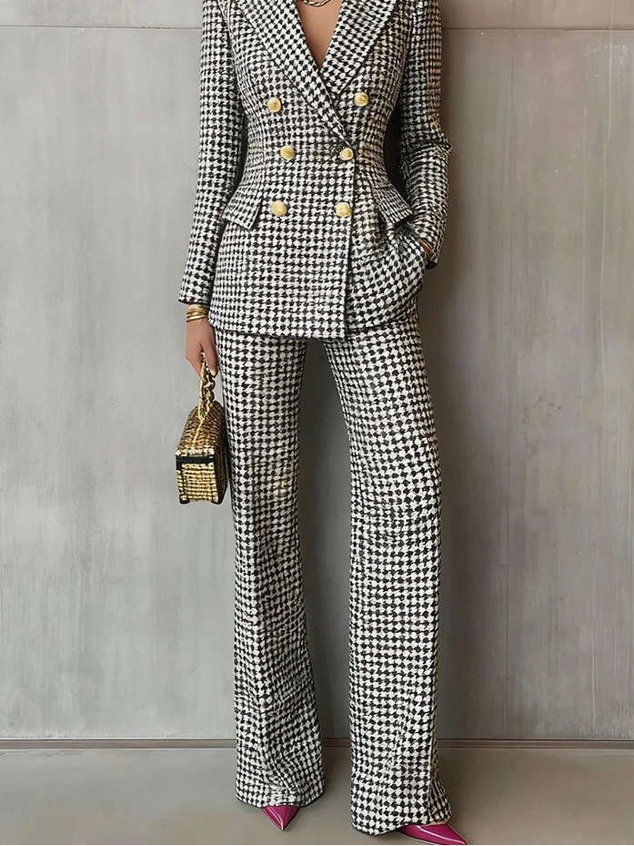 Person wearing a houndstooth patterned suit with a neutral background